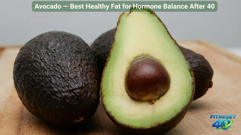 halved fresh avocado on wooden board a healthy fat food that helps balance hormones naturally
