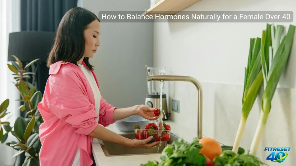 woman over 40 cooking hormone-balancing foods in kitchen showing how to balance hormones naturally as a female